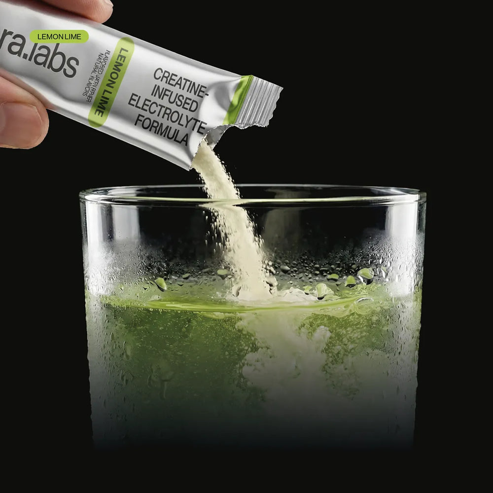 Pouring a Rephora Lemon Lime creatine stick into a glass of water